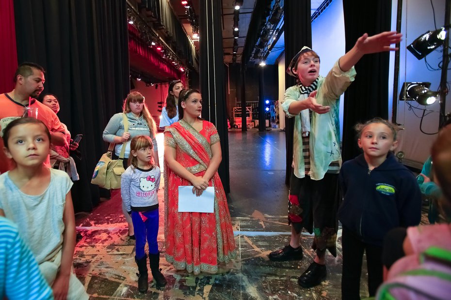 Hunter Katz leads a group taking part in the Youth in Arts program at Balboa Park through a back stage tour of the Casa del Prado Theatre in Balboa Park.